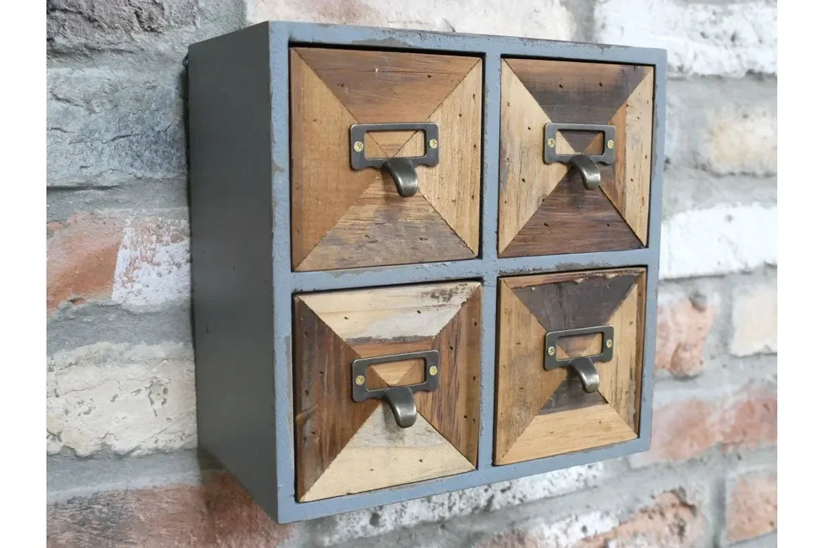 Rustic wood storage cabinet with four drawers and metal handles mounted on stone wall
