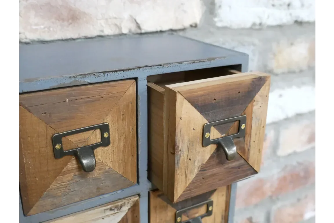 Rustic wood and metal storage drawers with metal handles against brick wall