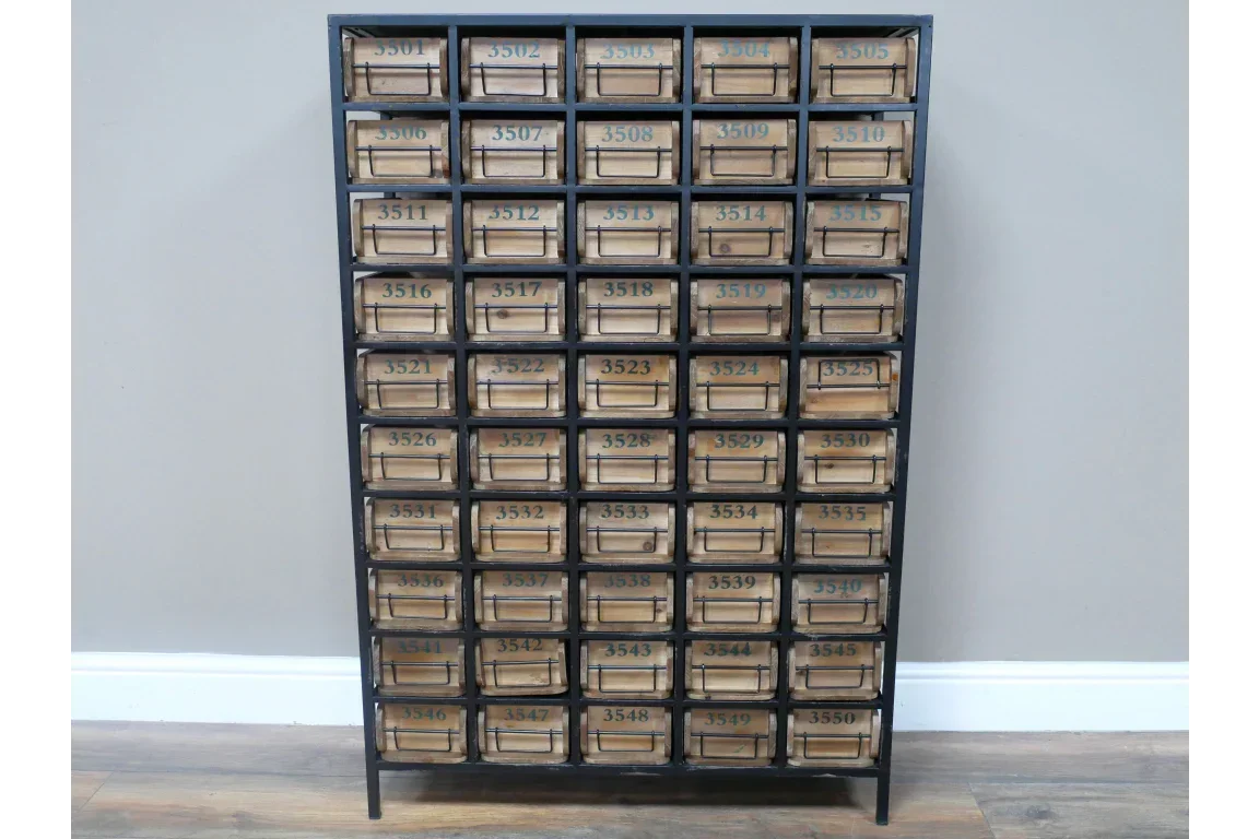 Industrial storage cabinet with numbered wooden drawers and black metal frame