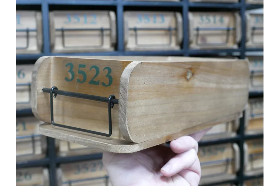 Rustic wooden storage drawer with metal handle and green numbered front panel