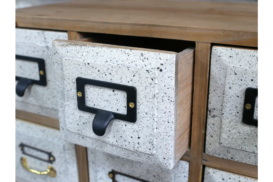 Speckled wood cabinet with metal label holders and one open drawer, close view