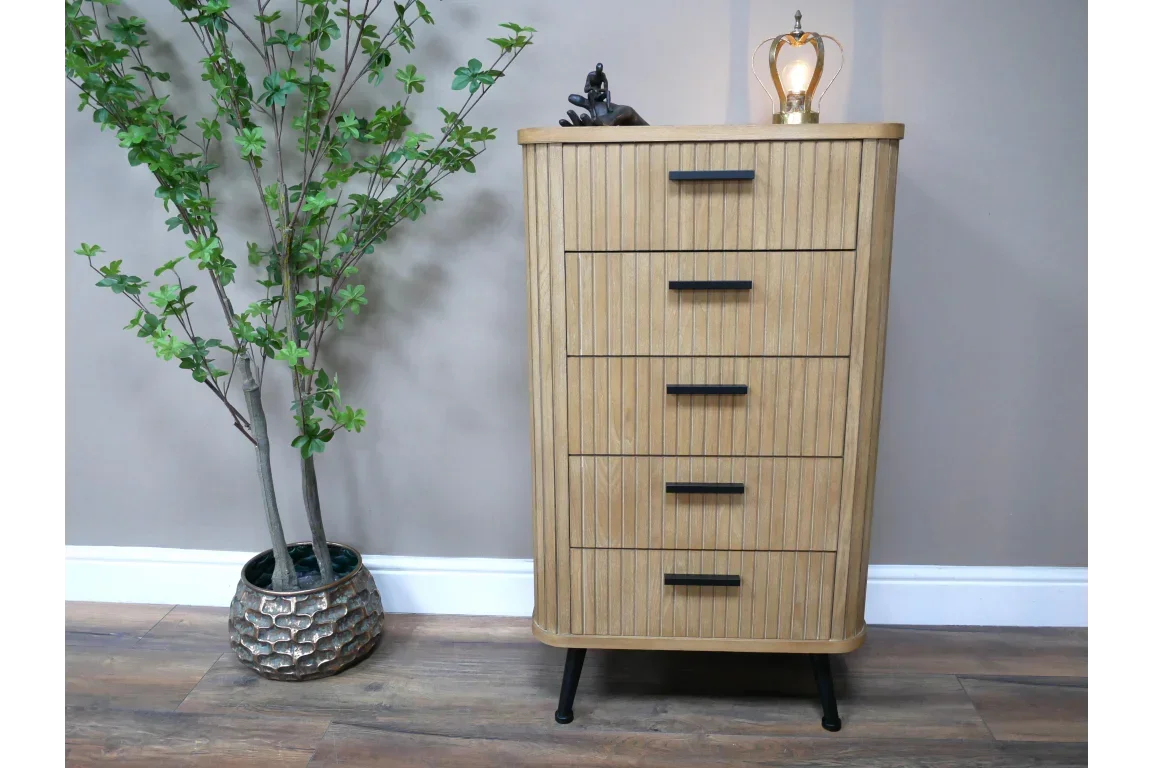 Oak chest of drawers with five vertical panels and black handles, set on angled legs