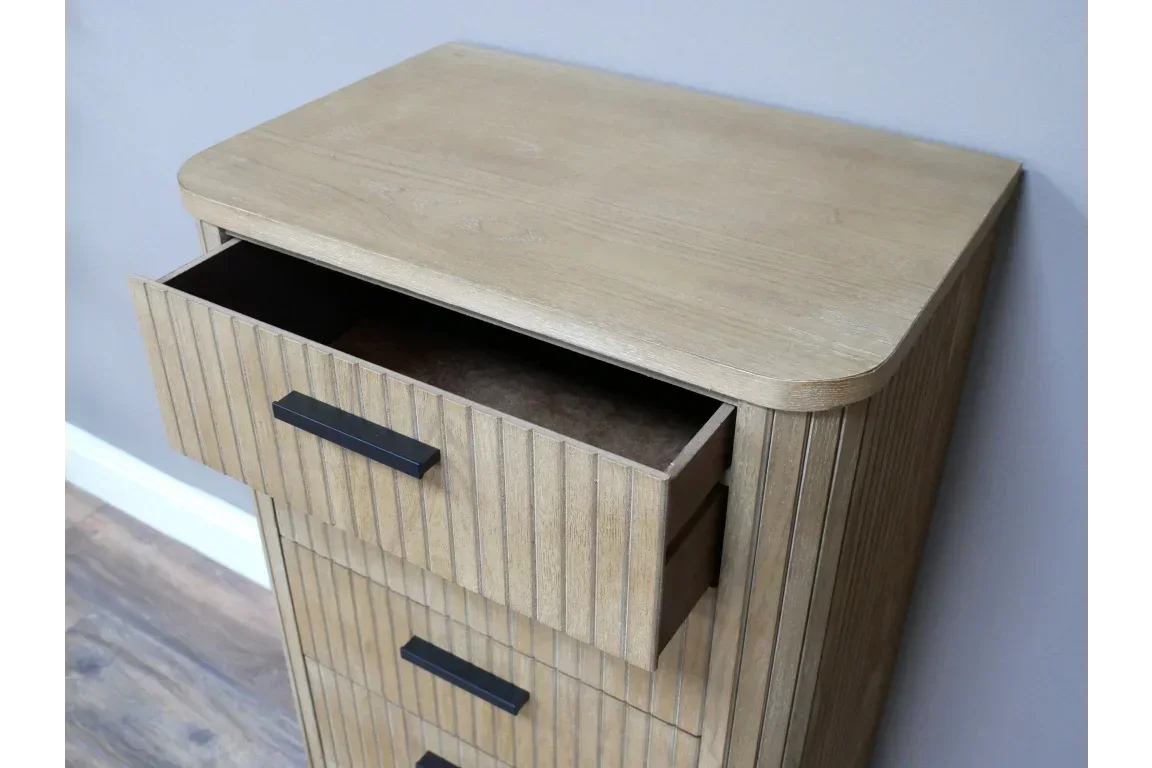 Oak chest of drawers with vertical grooves and black handles, top drawer open
