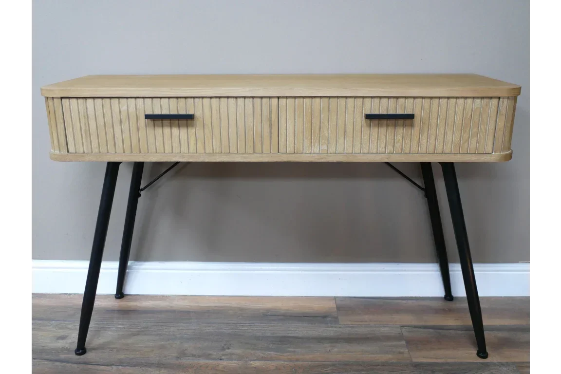 Wooden console table with two drawers and black angled legs on laminate flooring
