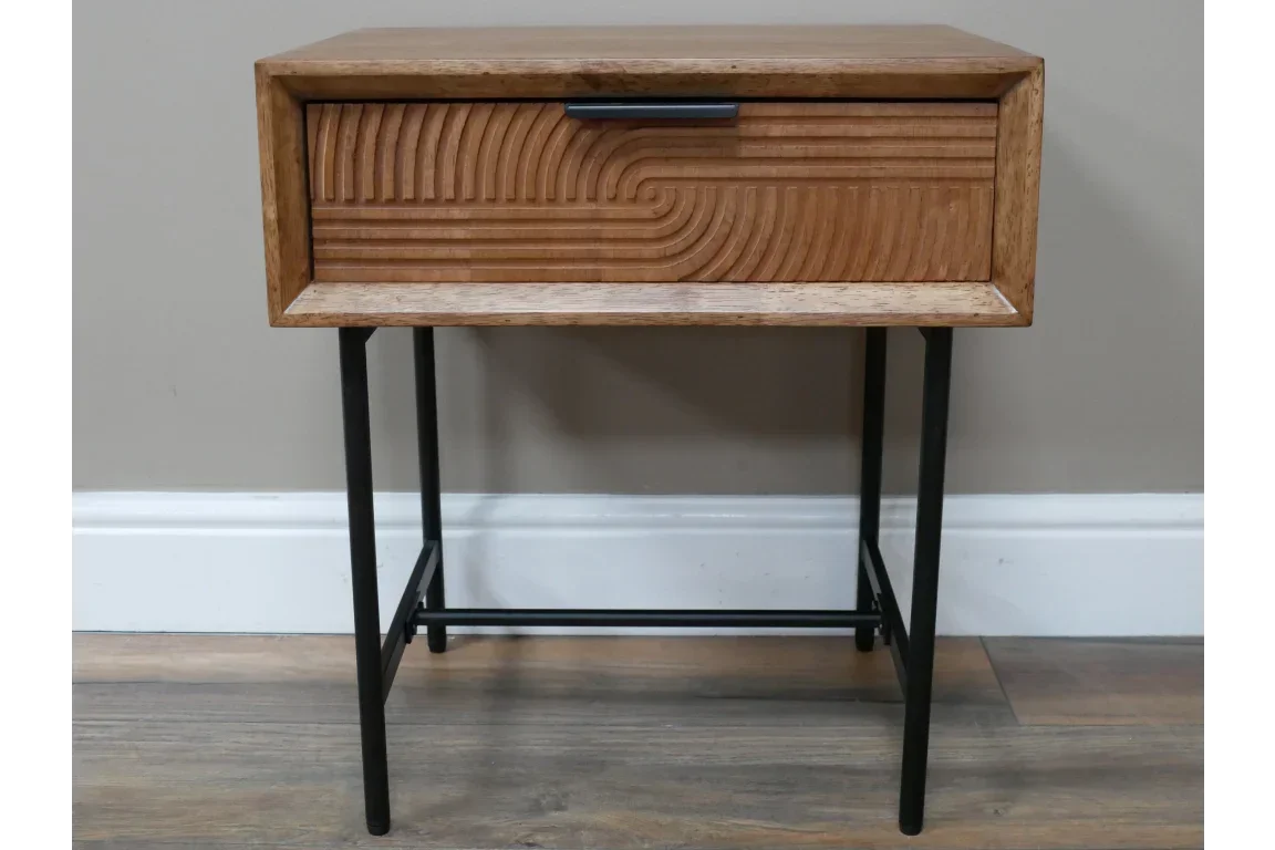 Wooden bedside table with carved drawer front and black metal legs