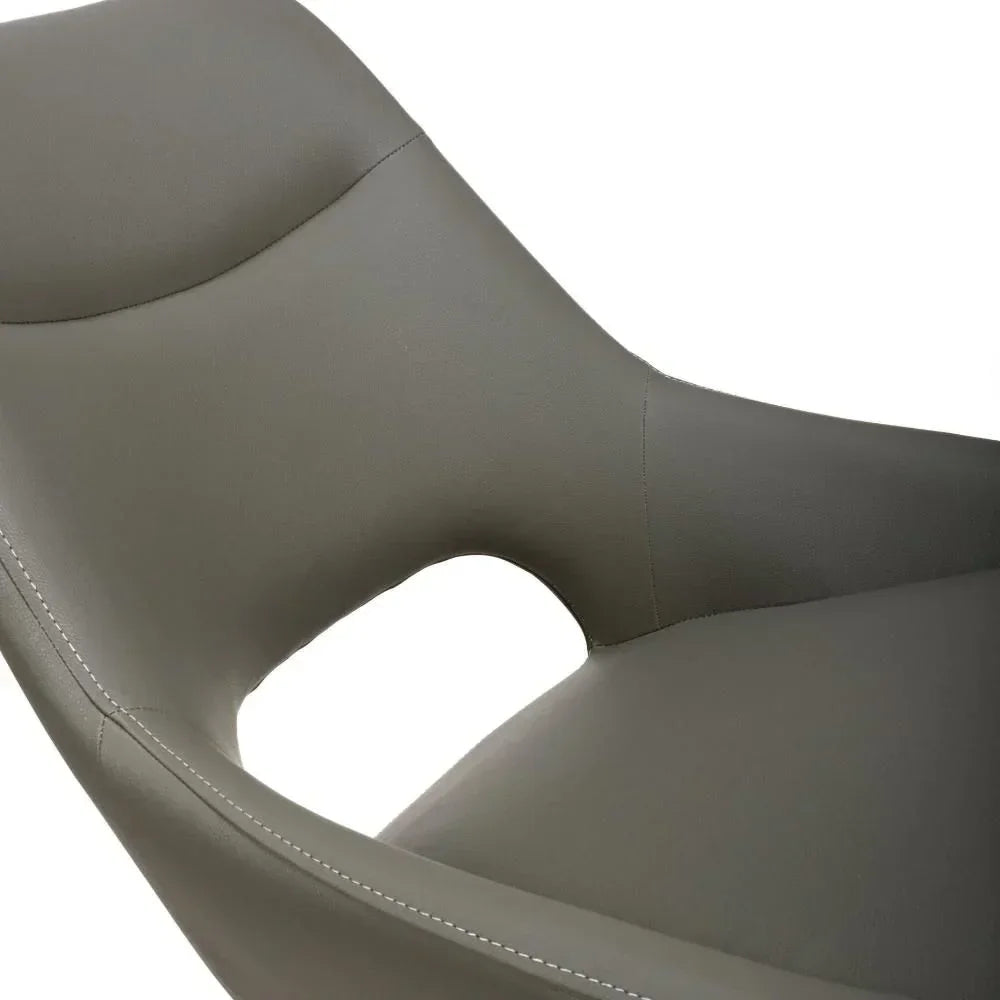 Close-up of modern grey dining chair with faux leather upholstery and stitched detail