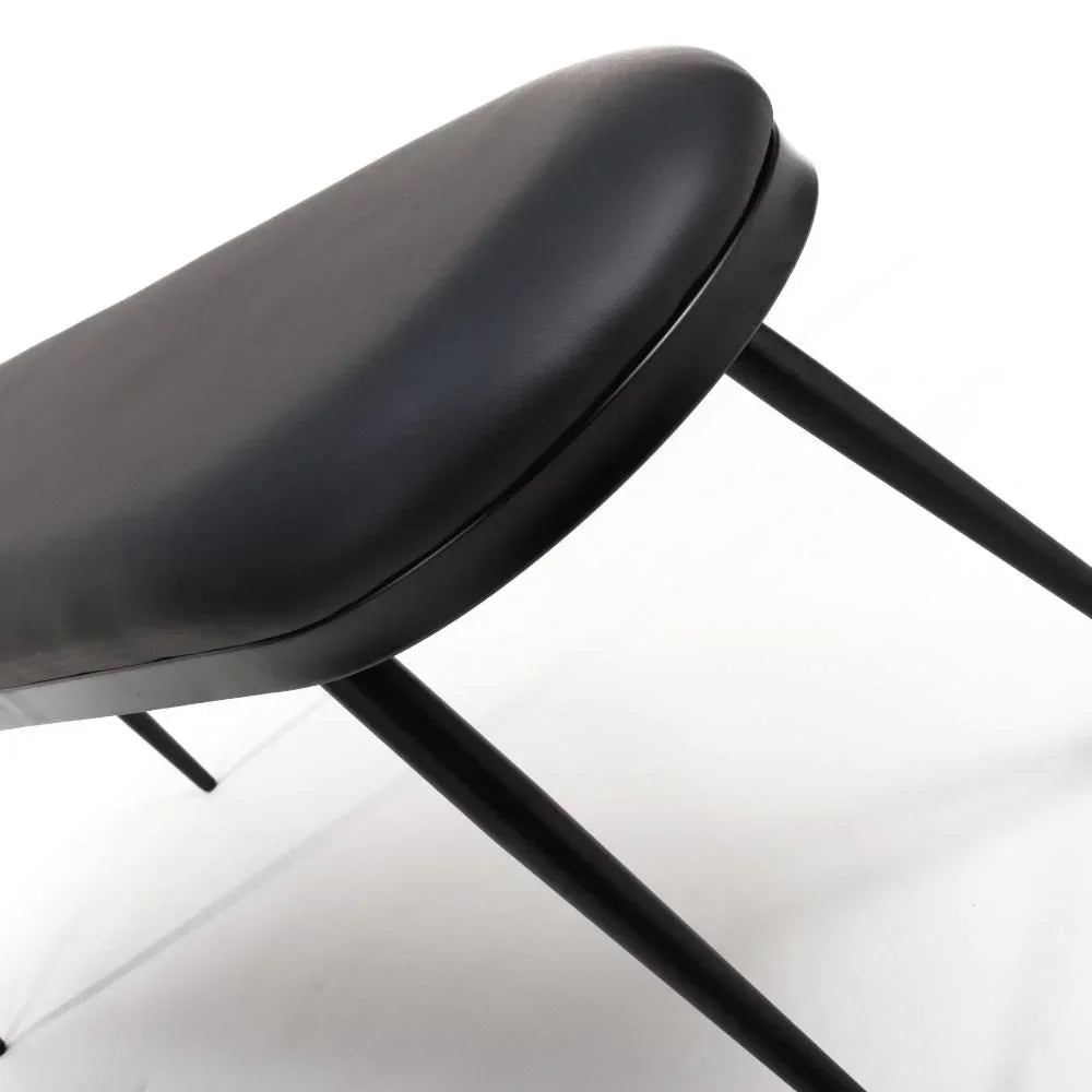 Black dining chair with padded seat and slim metal legs, angled side view