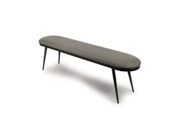 Modern upholstered dining bench with slim black legs and grey seat, angled side view