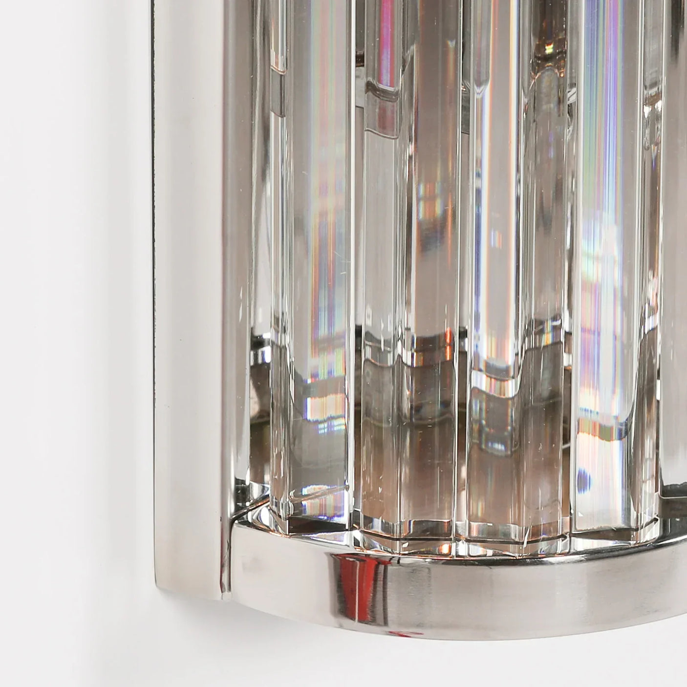 Close-up of chrome and crystal wall light fixture with vertical glass panels