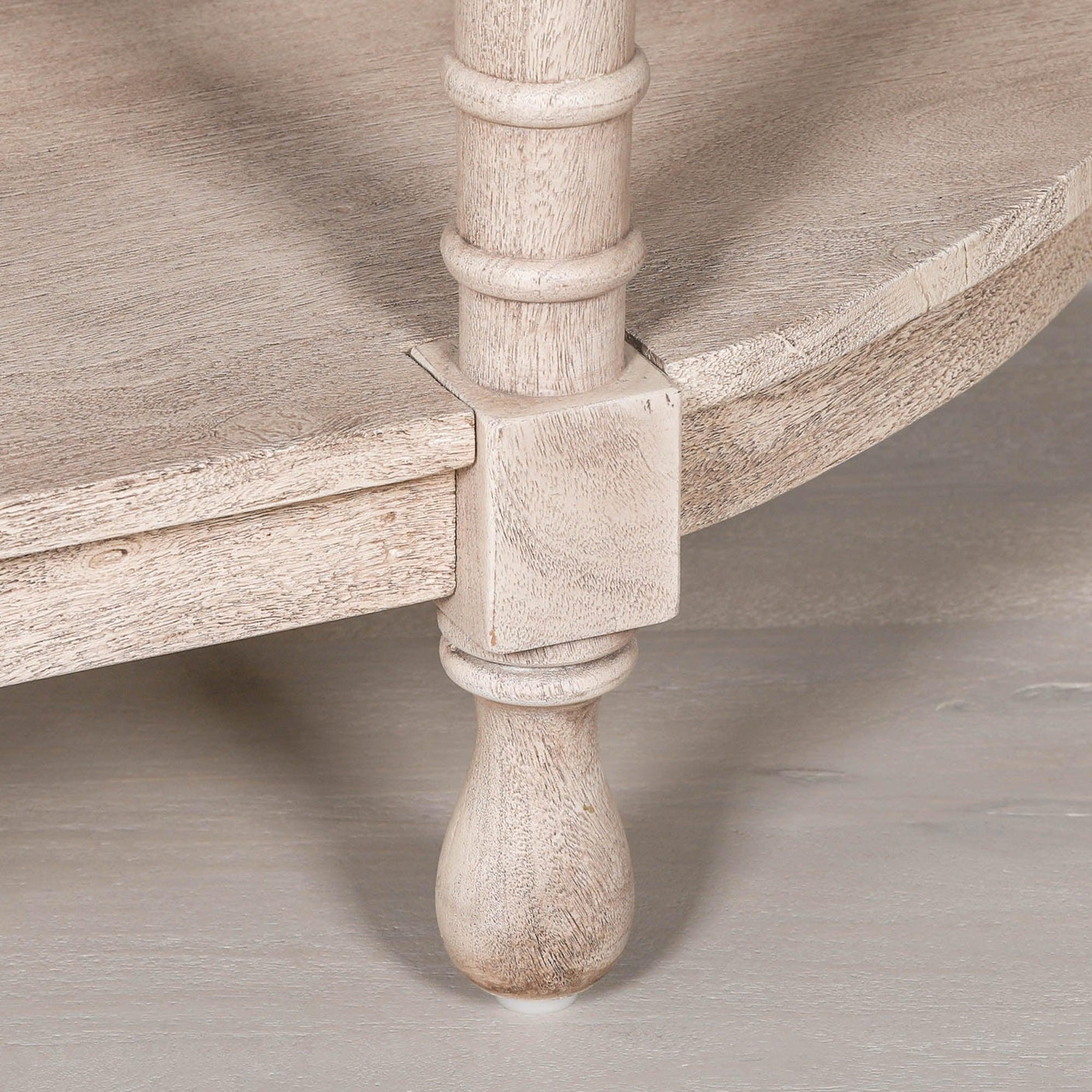 Light wood furniture leg with turned detail and lower shelf corner
