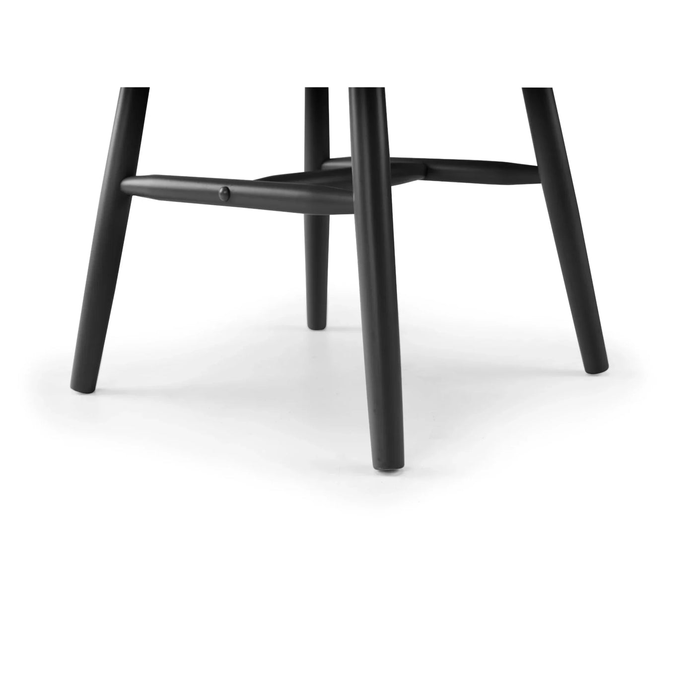 Black wooden chair legs with crossbar support on white background