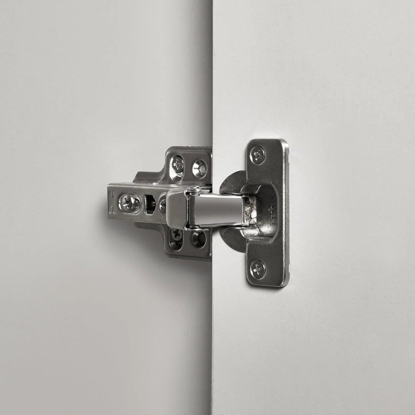 Silk grey wardrobe door with close-up of metal hinge detail