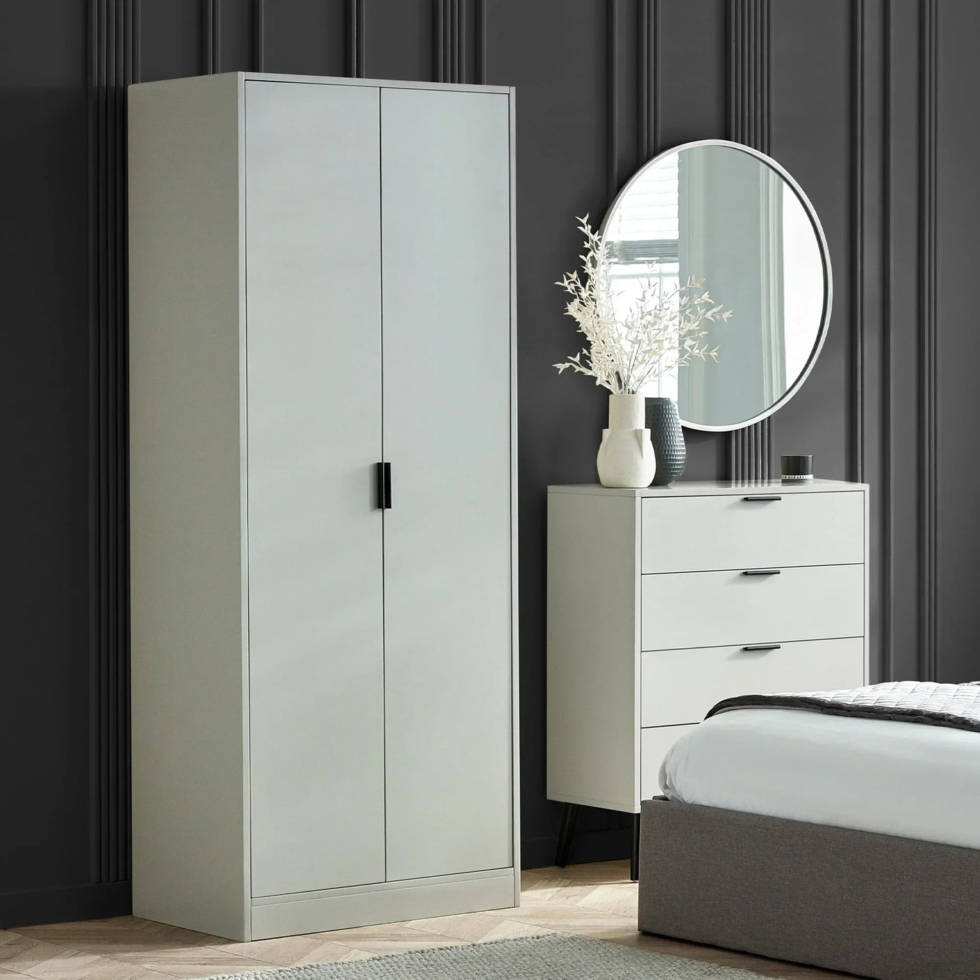 Silk grey 2 door wardrobe in modern bedroom with matching drawers and round wall mirror