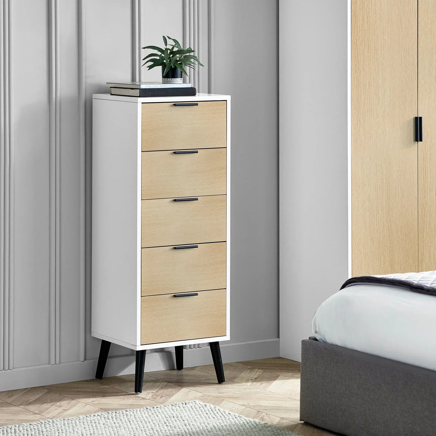 White and oak 5 drawer chest with black handles in modern bedroom