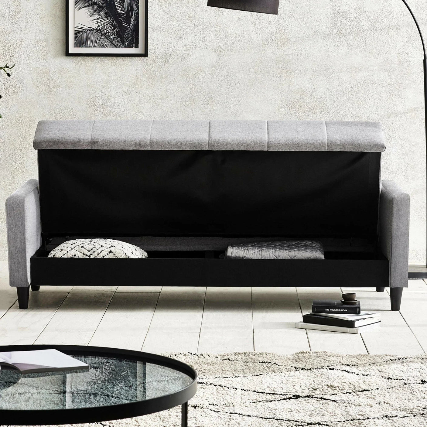 Grey storage sofa with lift-up seat, showing hidden compartment and cushions