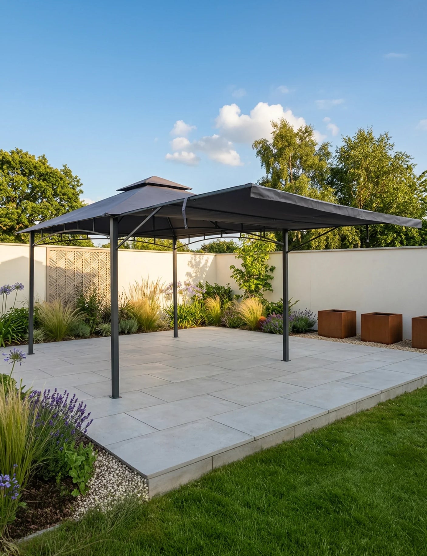 Grey metal garden gazebo with canopy on paved patio surrounded by plants