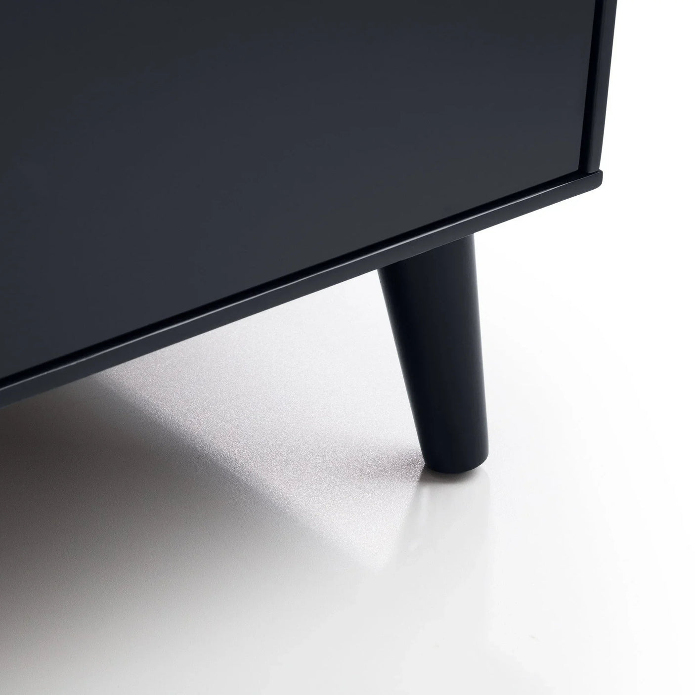 Anthracite chest of drawers leg detail on smooth white floor