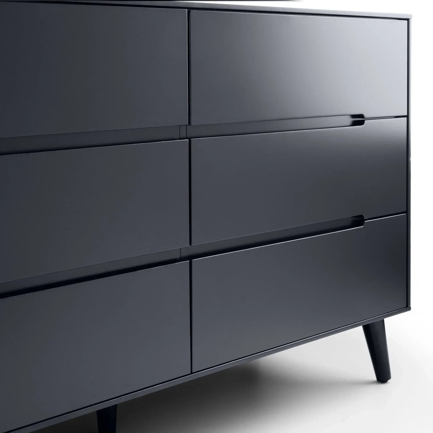 Anthracite wide chest of drawers with sleek handleless design and angled legs, side view