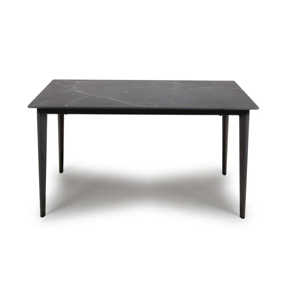 Rectangular black dining table with marble-effect top and tapered legs, front view