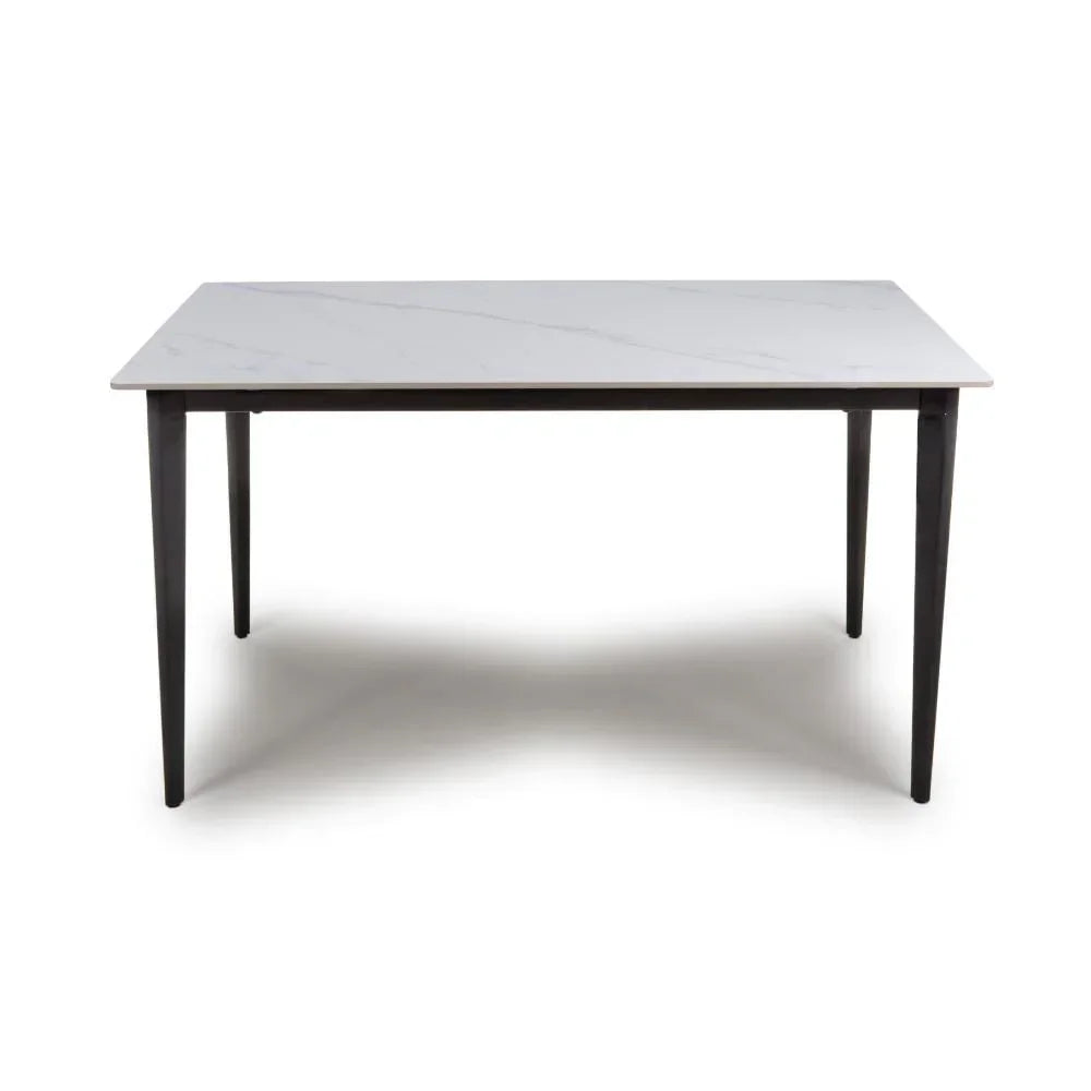 Rectangular dining table with white marble-effect top and black legs, front view