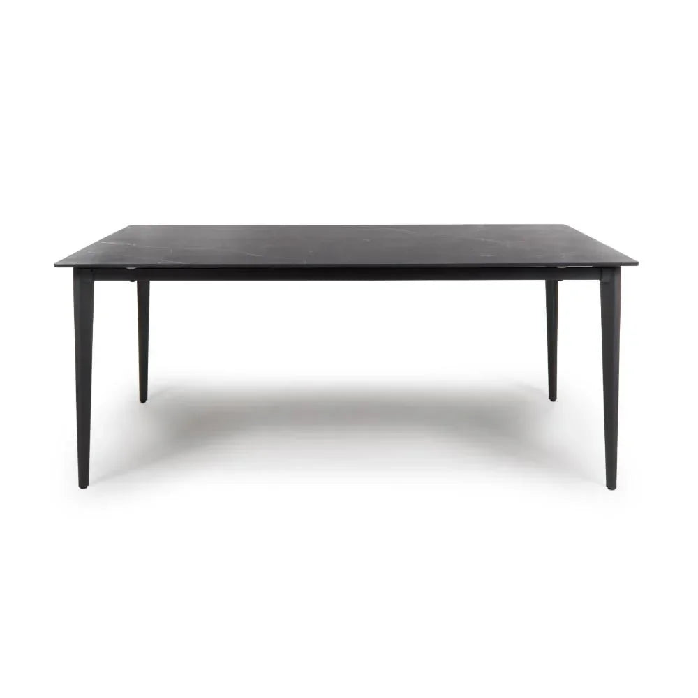 Black rectangular dining table with slim tapered legs and matte finish, front view