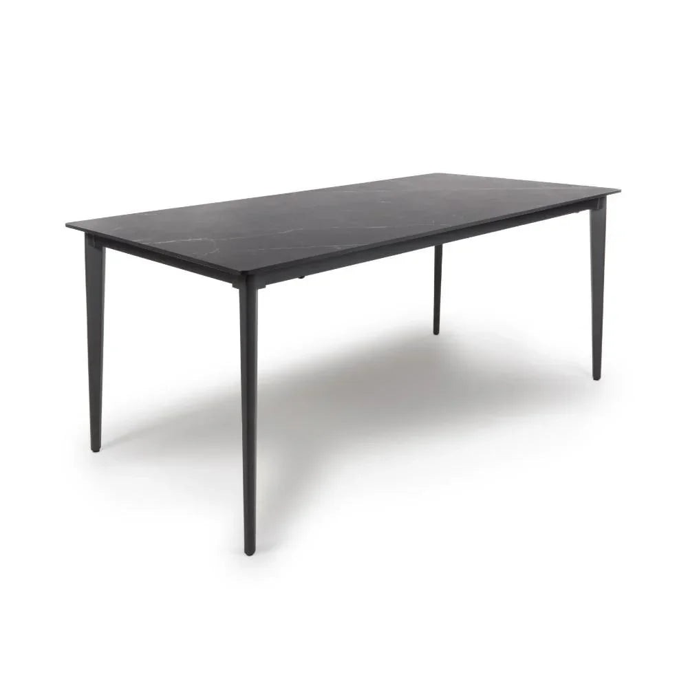 Black rectangular dining table with slim legs and marble effect top