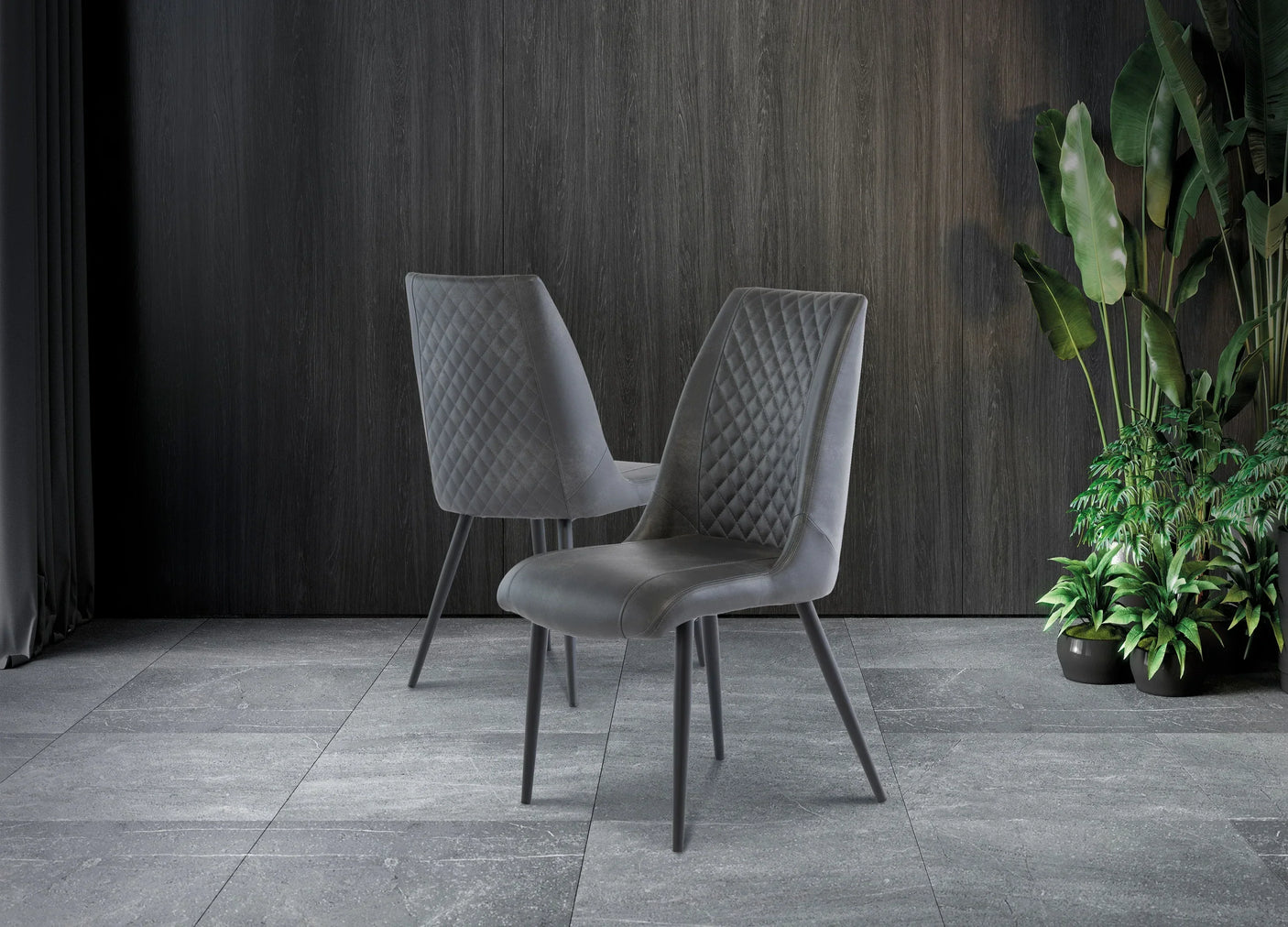 Grey velvet dining chairs with diamond stitching and angled legs on tiled floor