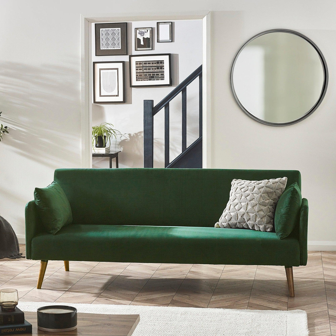 Green sofa bed with wooden legs and textured cushion in modern living room