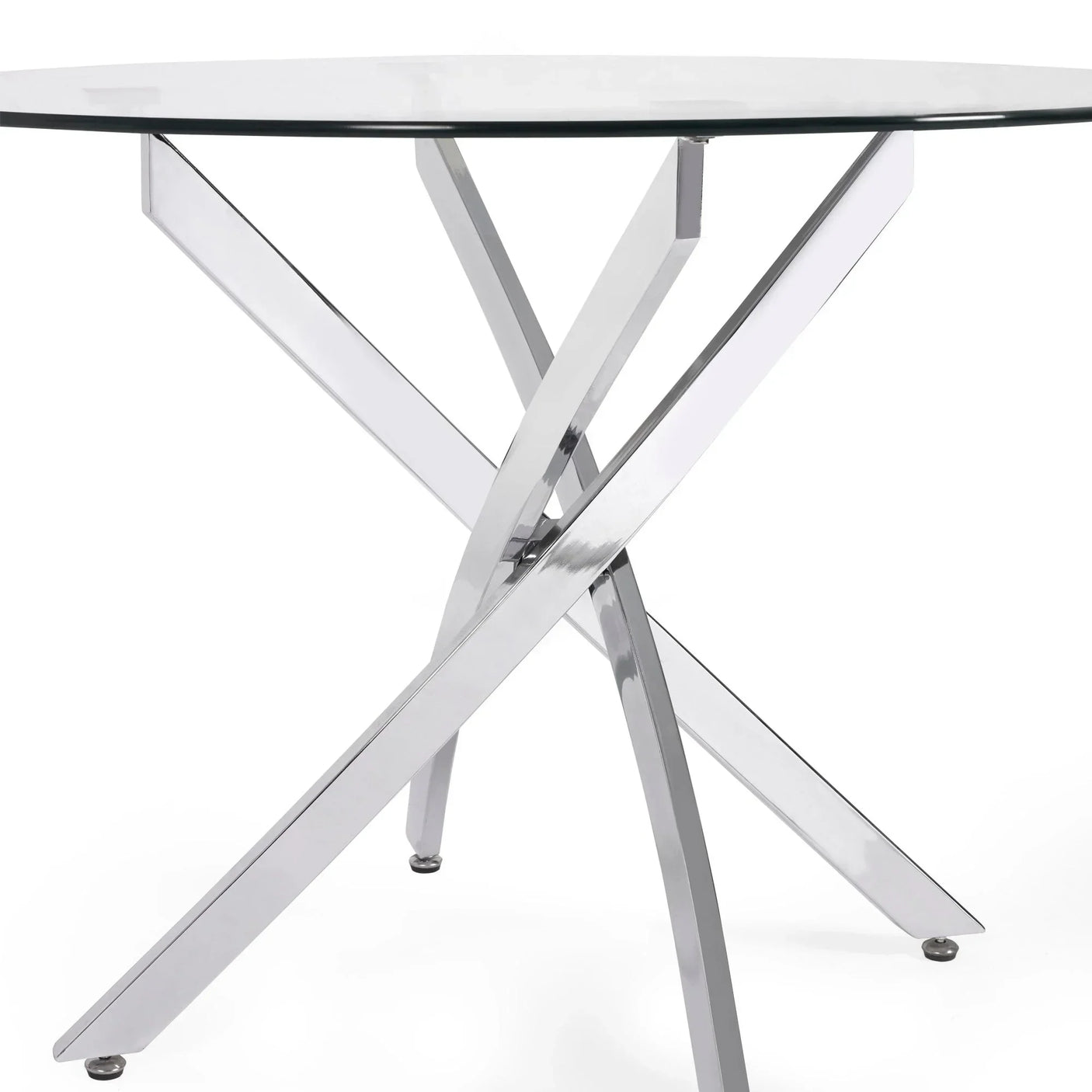 Round glass dining table with polished metal crossed legs close-up