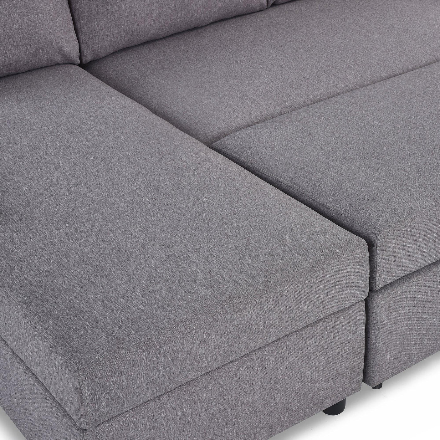 Close-up of grey fabric sofabed with storage feature and cushioned seating