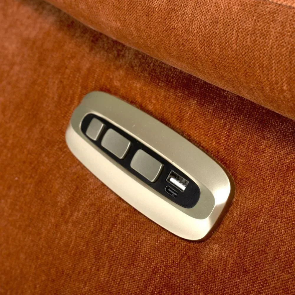 Close up of recliner sofa control panel with USB ports on textured rust fabric