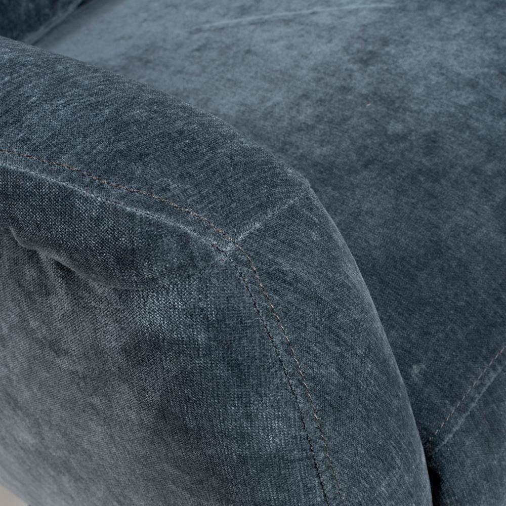 Dark grey fabric sofa armrest with visible stitching detail