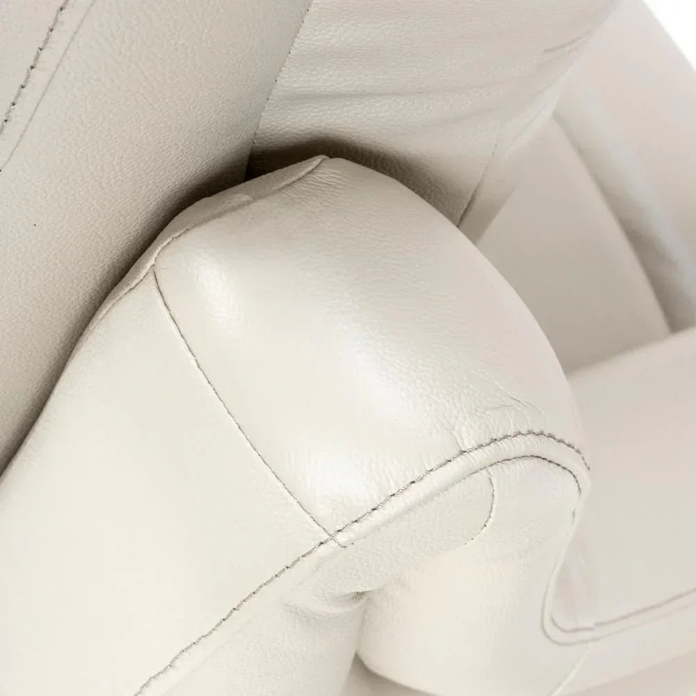 Close-up of cream leather armchair stitching and padded armrest detail