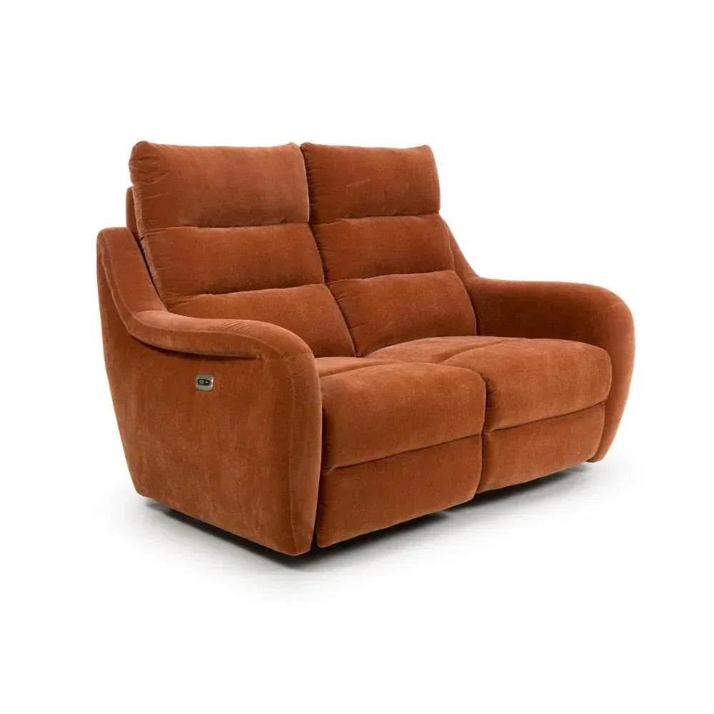 Rust fabric reclining sofa with padded seats and armrests, angled view on white background