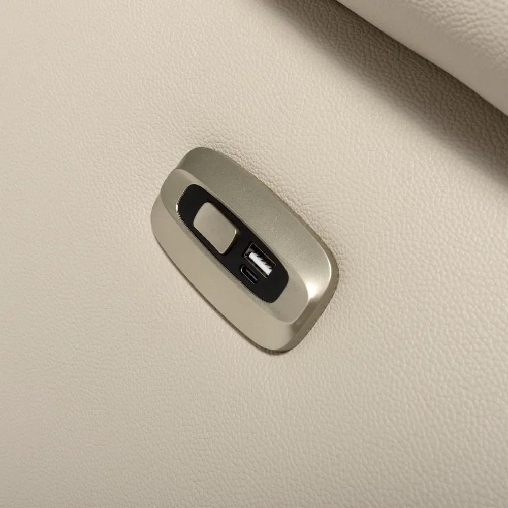 Close view of cream leather recliner sofa USB charging port and control button