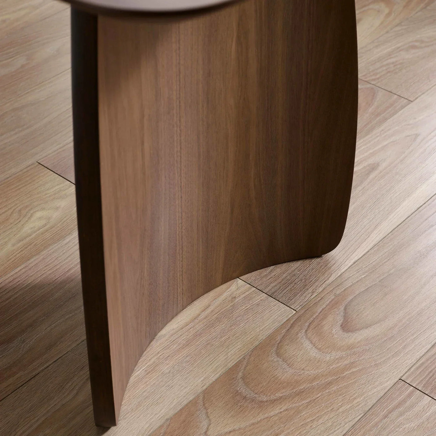 Close-up of wooden furniture leg on light oak flooring