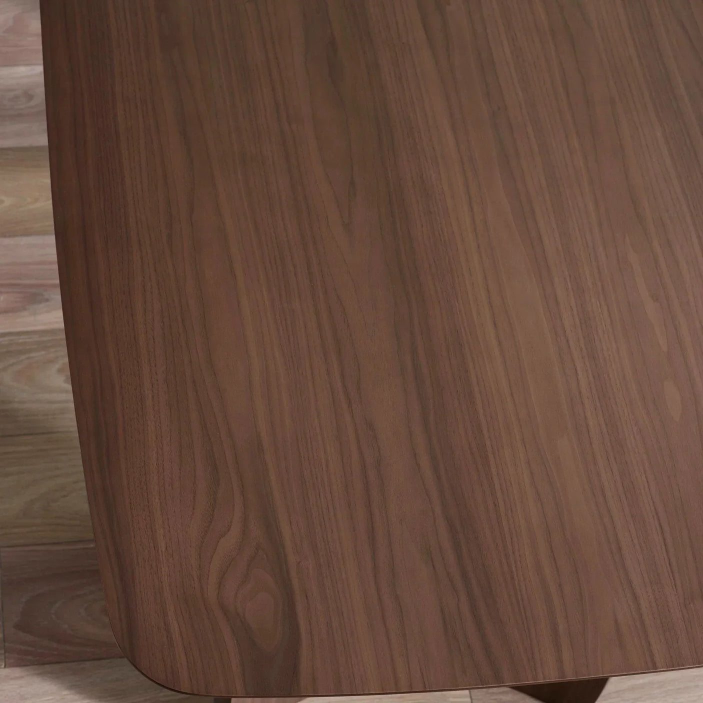 Rectangular dining table with smooth walnut wood grain finish and rounded corner detail