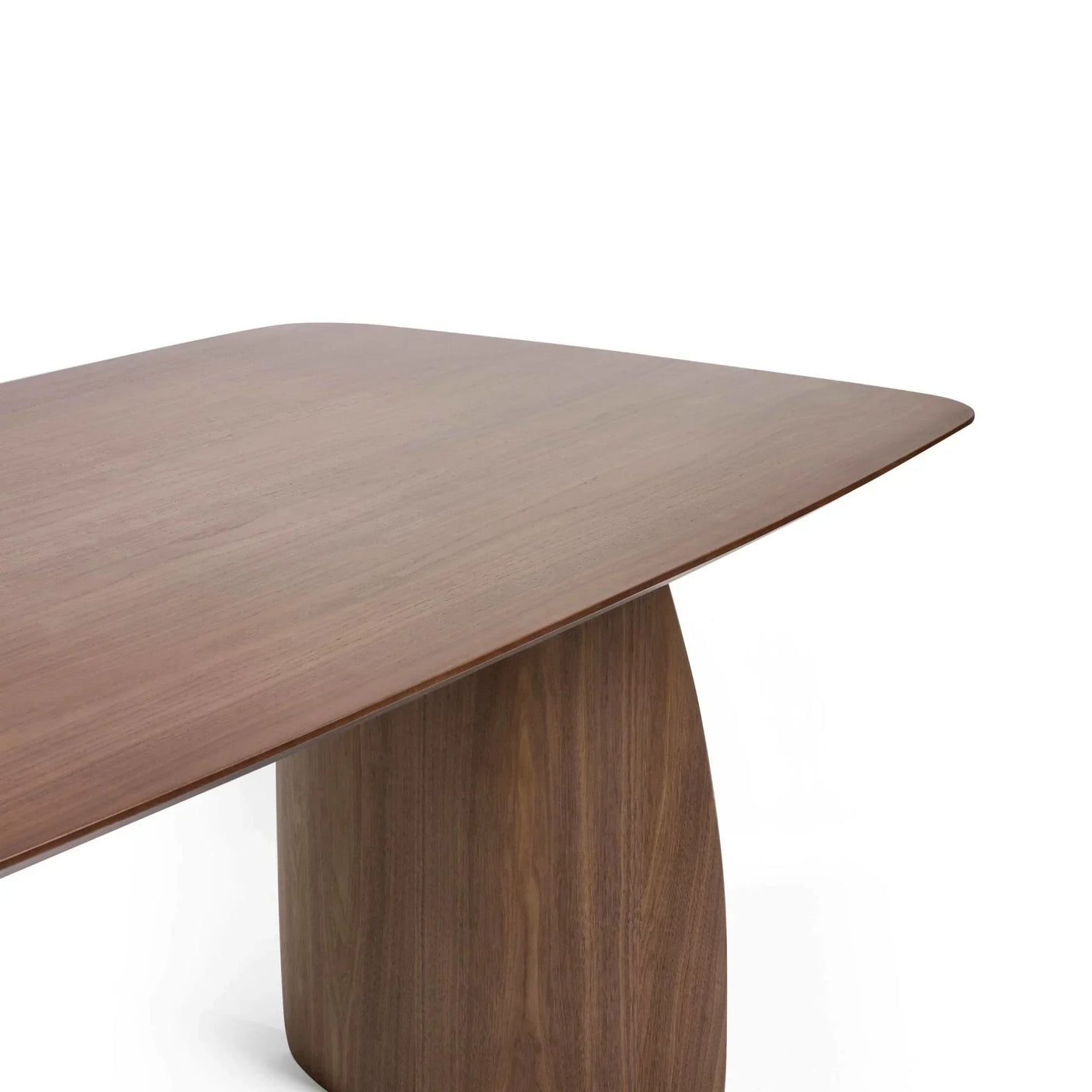 Walnut dining table with curved rectangular top and sculpted base, side angle view