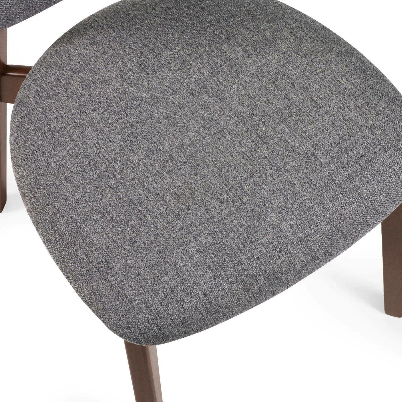 Close view of grey fabric dining chair seat with wooden legs