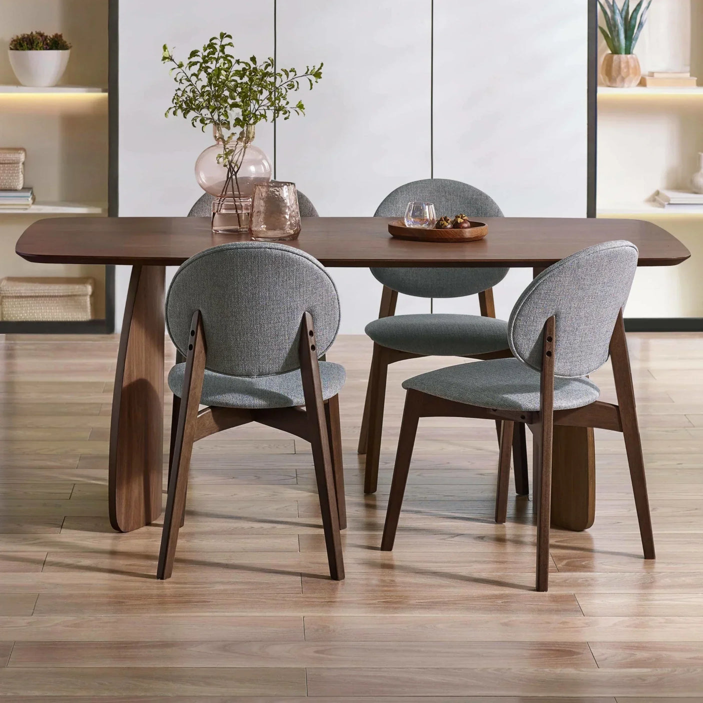 Walnut dining table with grey upholstered chairs in modern dining room