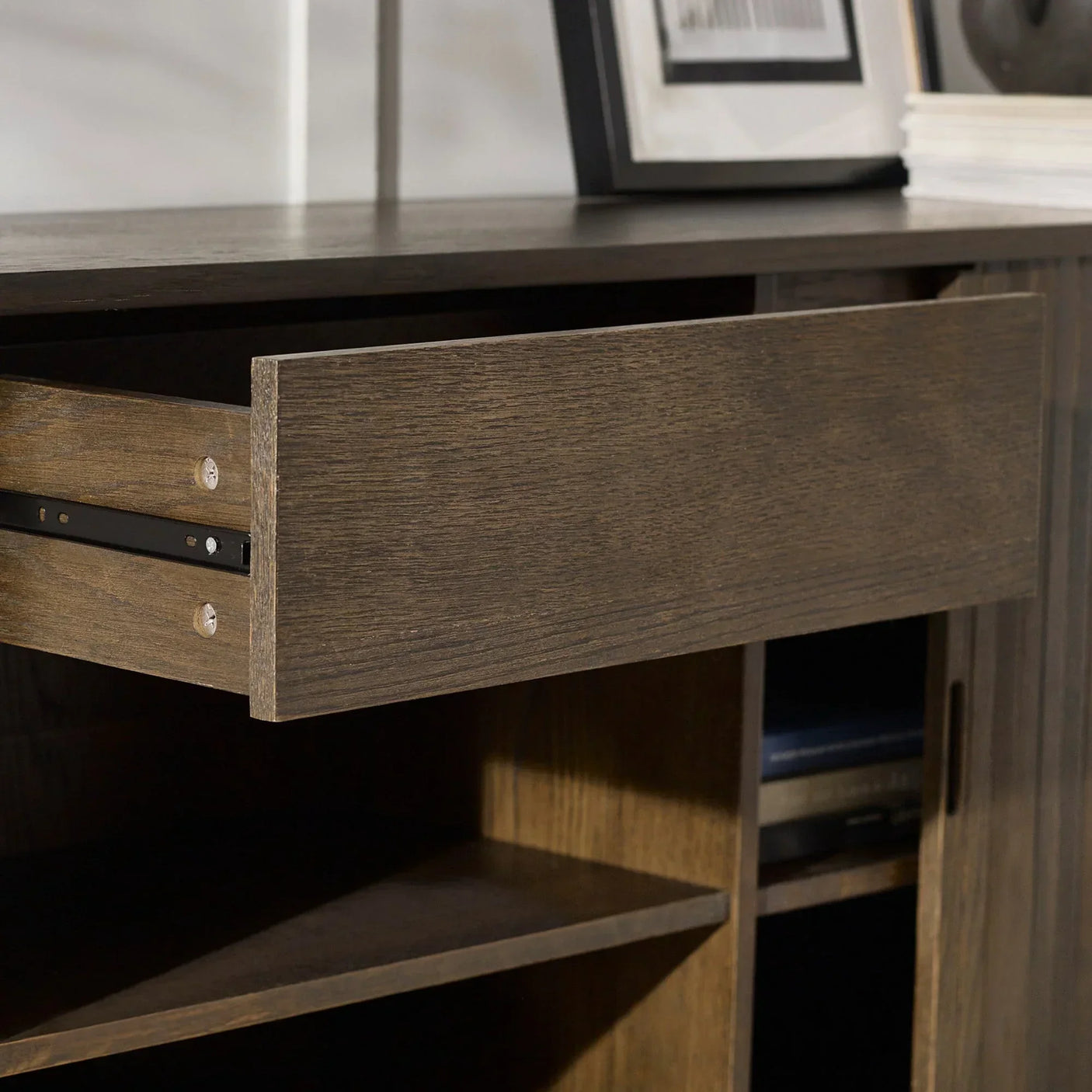Dark wood sideboard with open drawer and shelving compartments