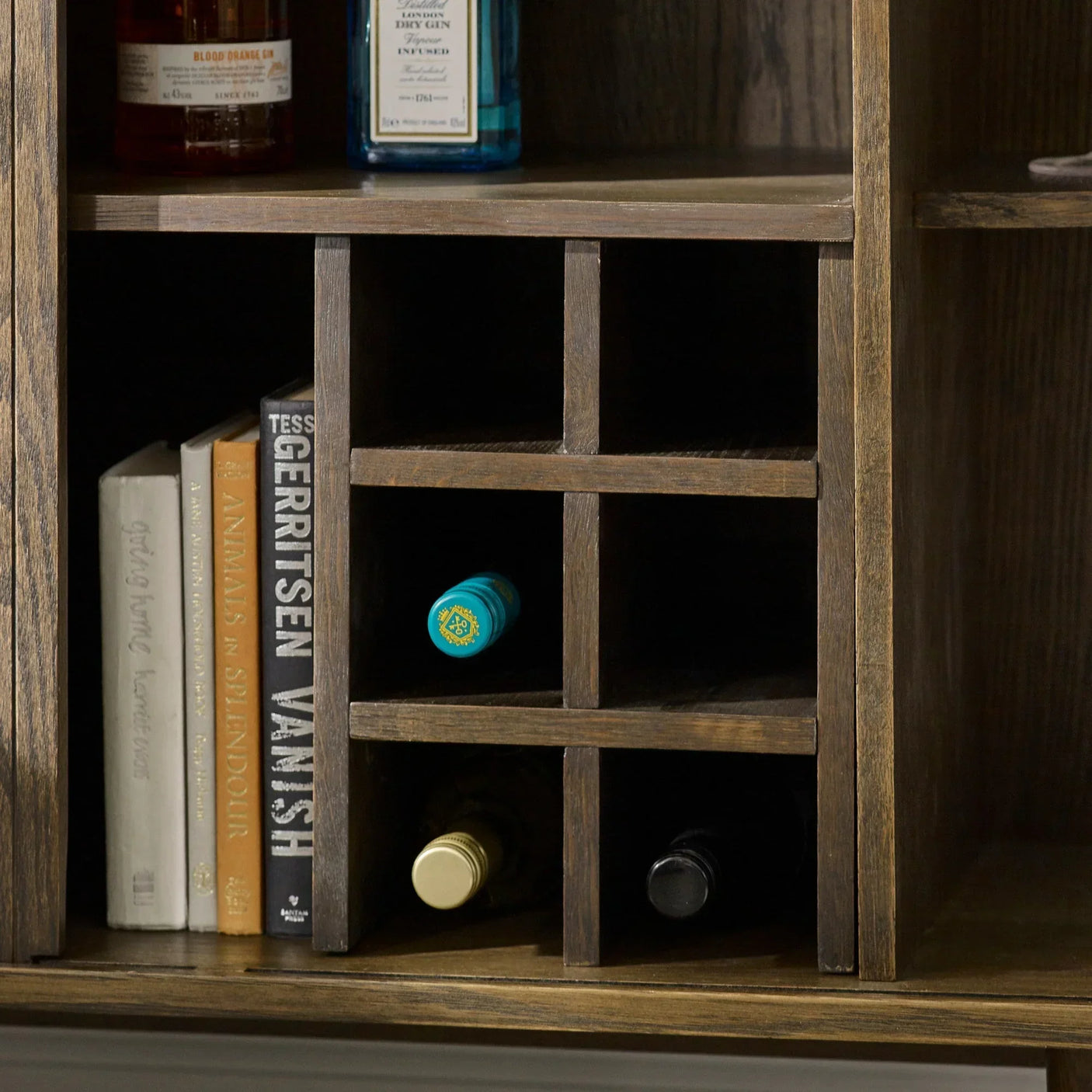 Wooden wine rack with horizontal bottle storage and books on shelf