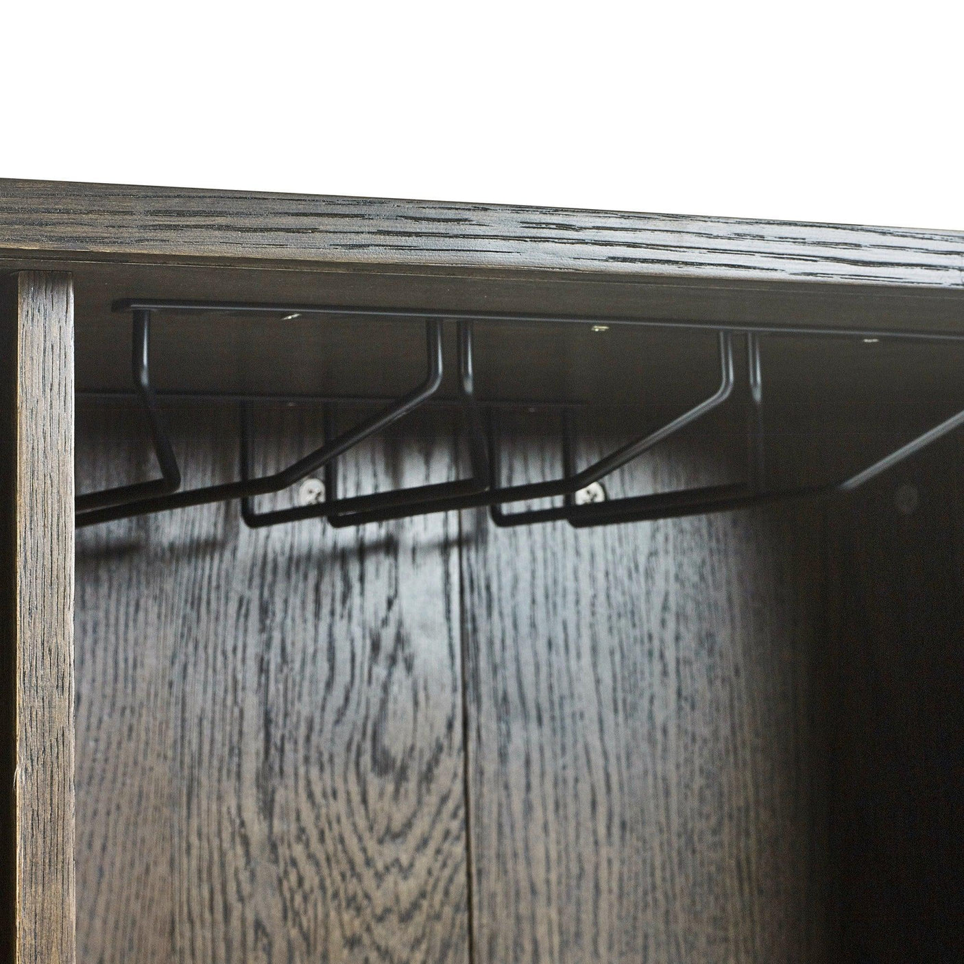 Dark wood wardrobe interior with metal hanging rail for coat storage