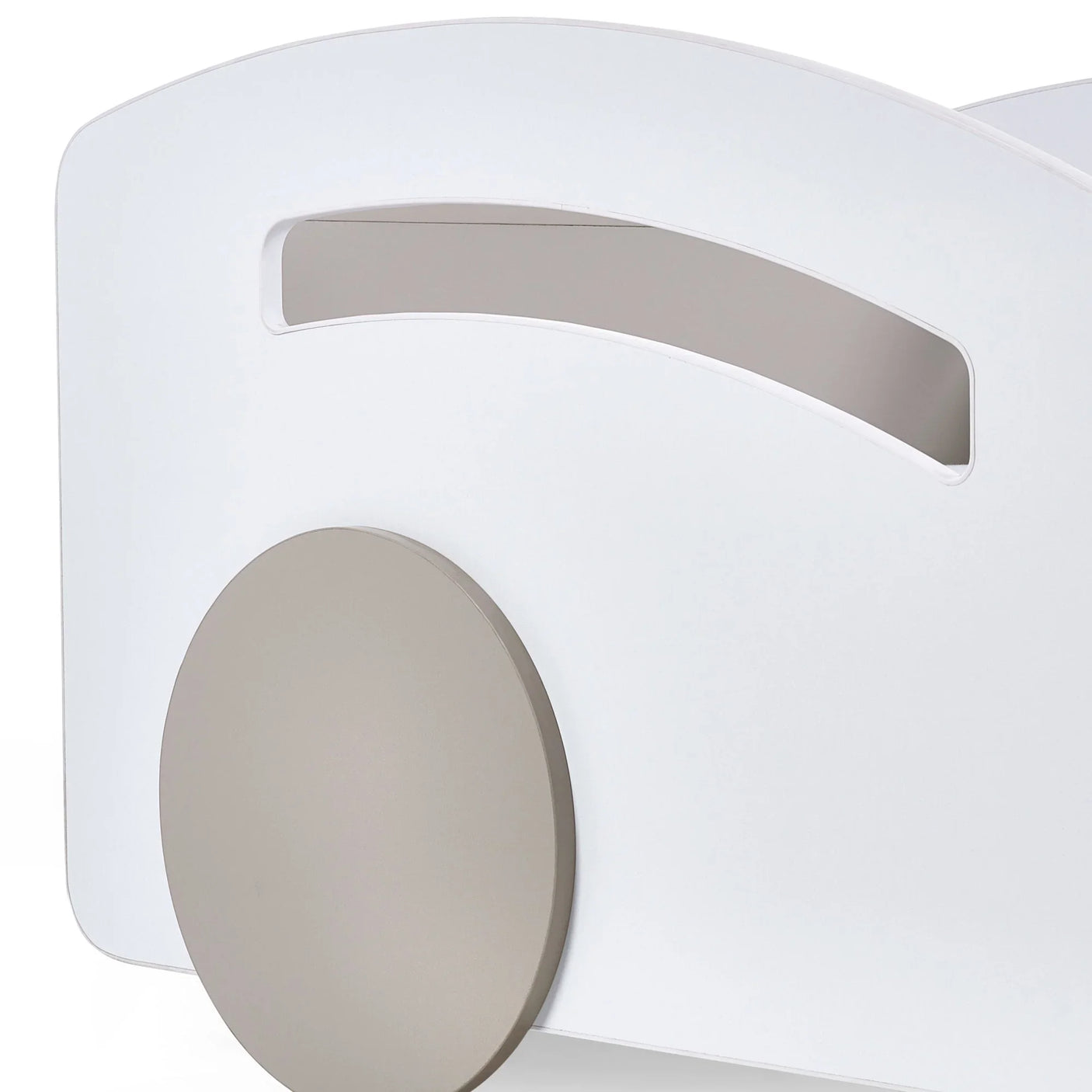 Closeup of white wooden furniture panel with circular taupe accent and cut-out handle