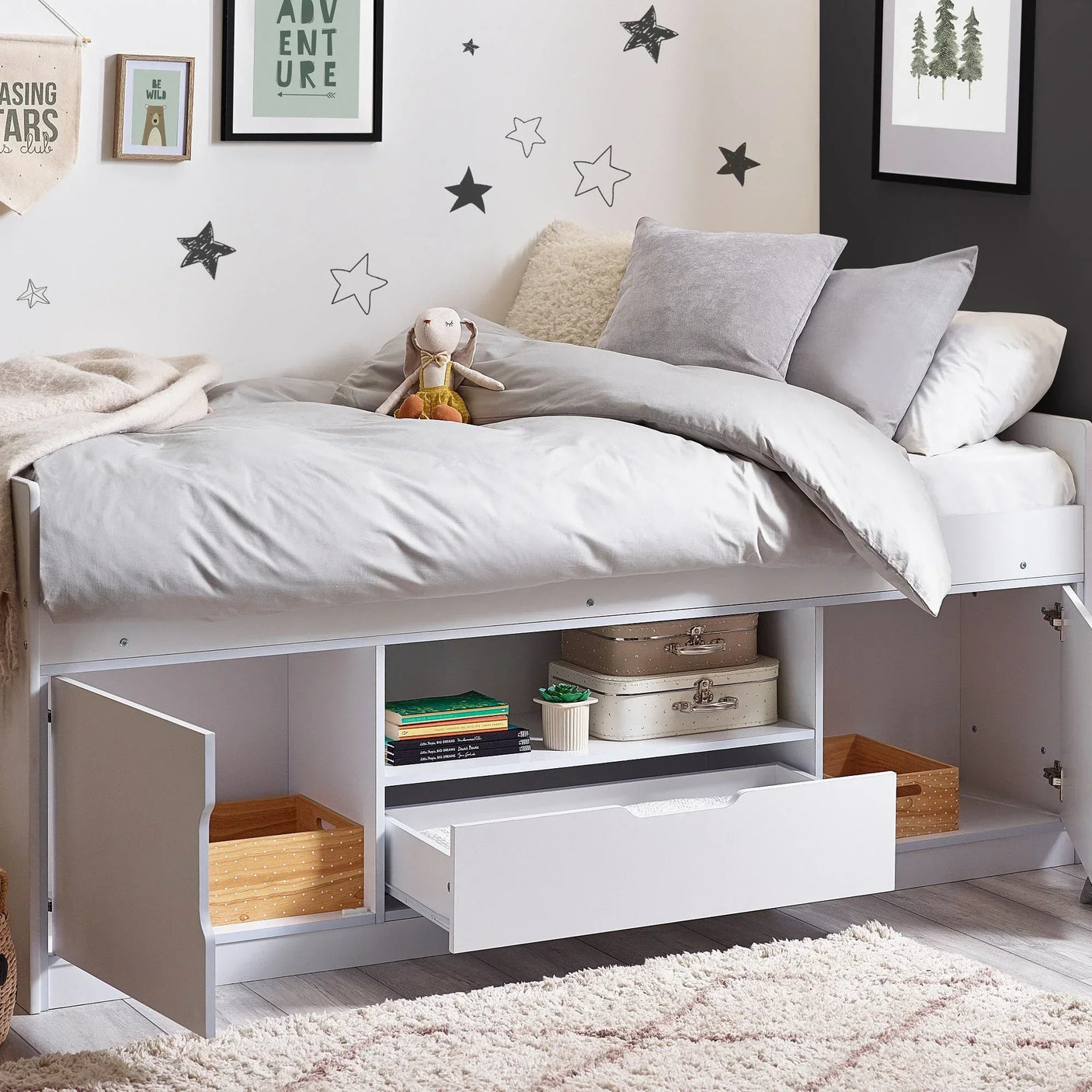 White low sleeper bed with storage drawers and cupboards in a modern kids bedroom
