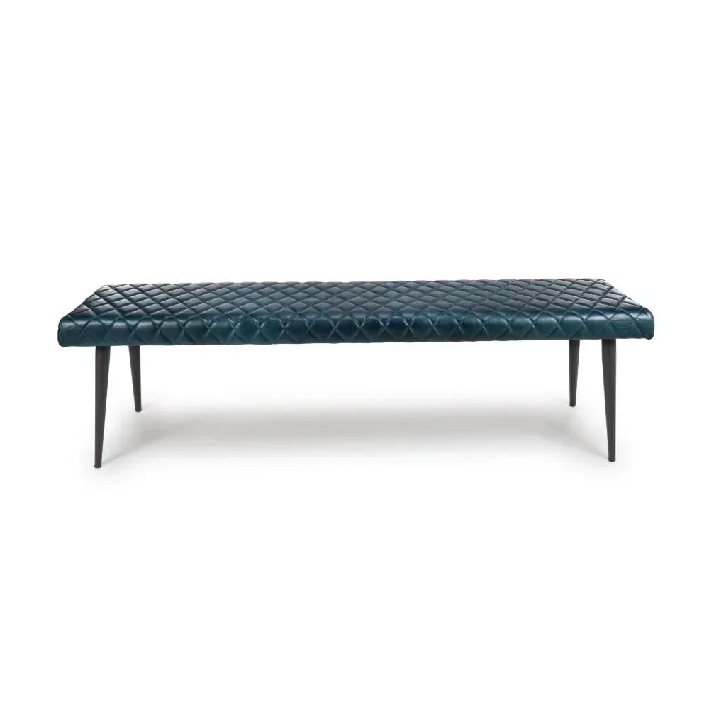 Blue quilted leather bench with black tapered legs, viewed from the front on white background