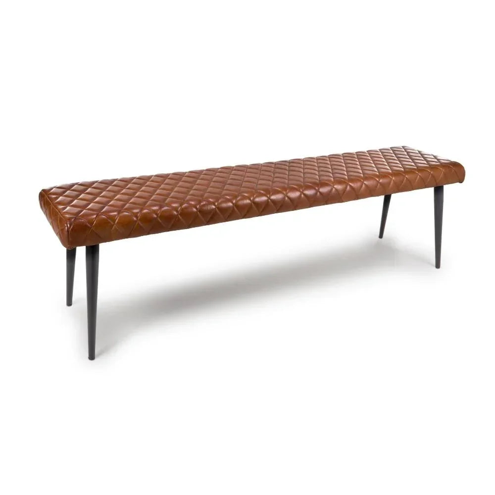 Brown leather bench with quilted seat and black tapered legs on white background