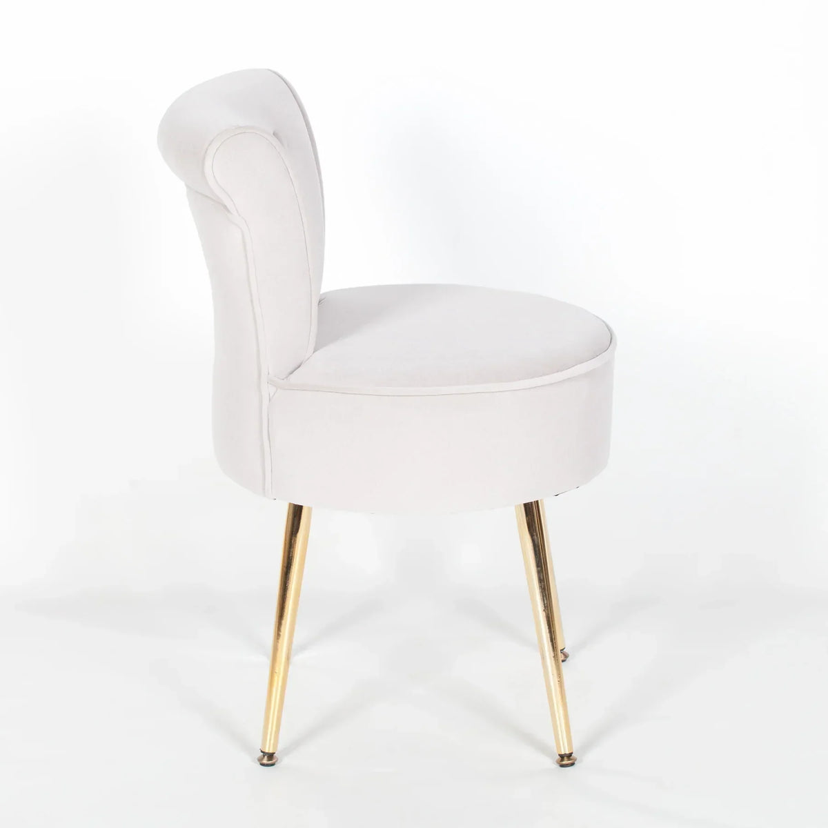 Velvet accent chair with curved backrest and gold metal legs on white background
