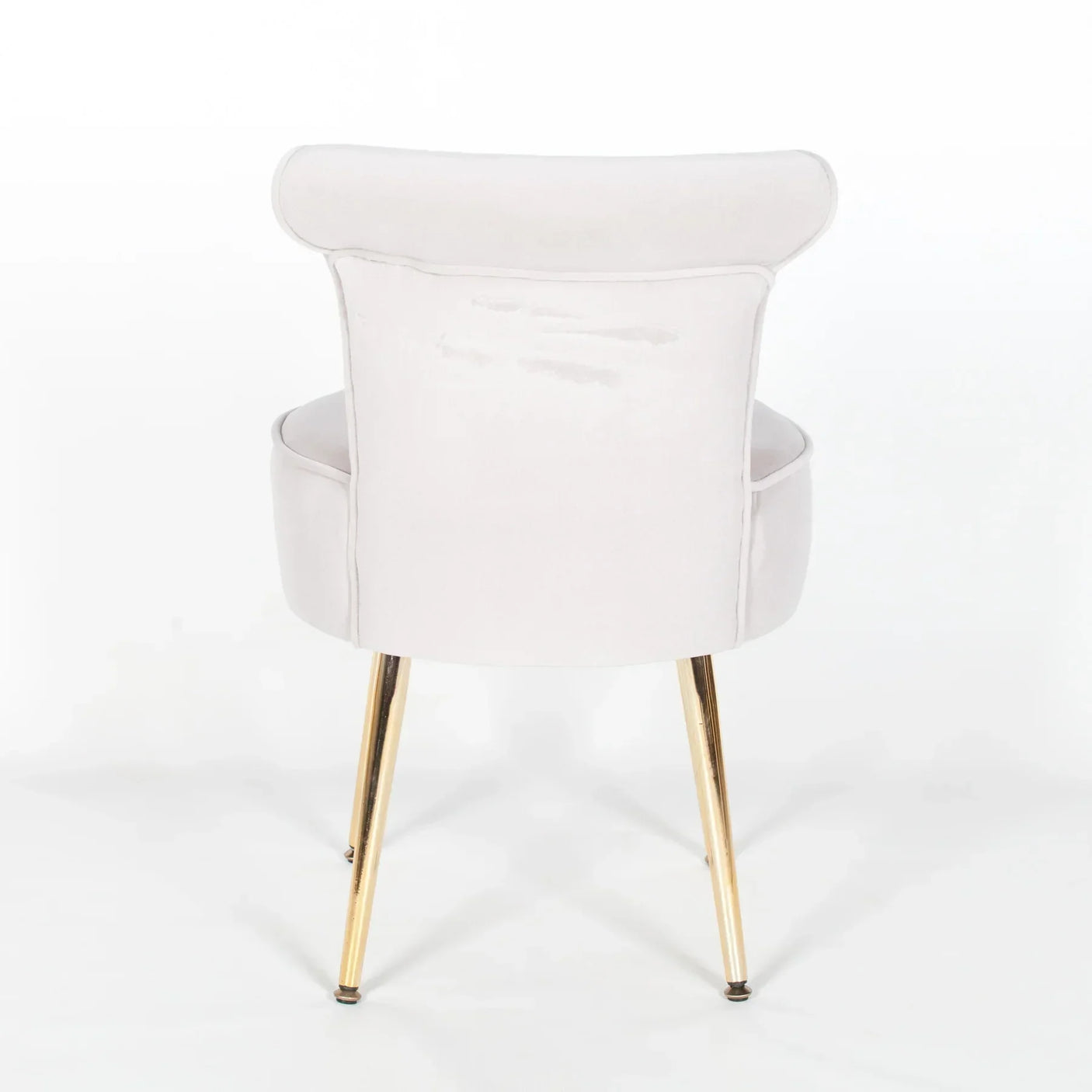 Back view of velvet accent chair with gold metal legs on white background