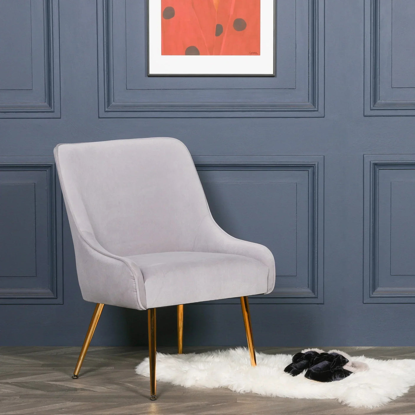 Light grey accent chair with gold metal legs in modern living room setting
